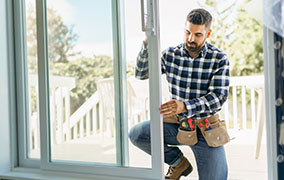 Man installing hurricane windows