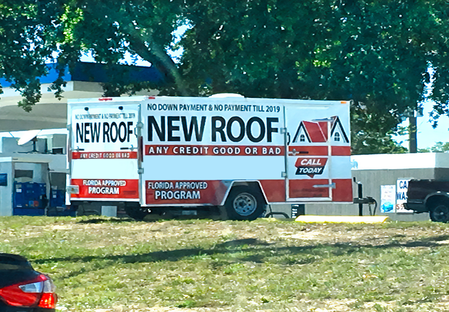 Free Roof Repair Advertisement on a trailer